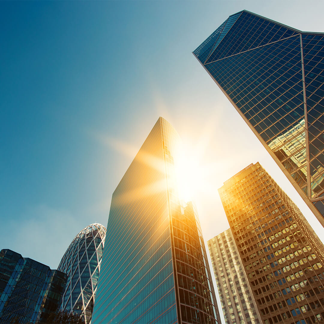 London skyscrapers with sun shining through them - Odgers Executive Search Board Headhunters