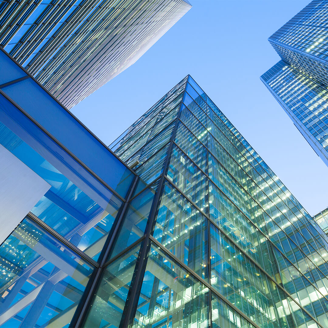 Looking up at modern glass skyscrapers in the city - Odgers Executive Search Board Headhunters