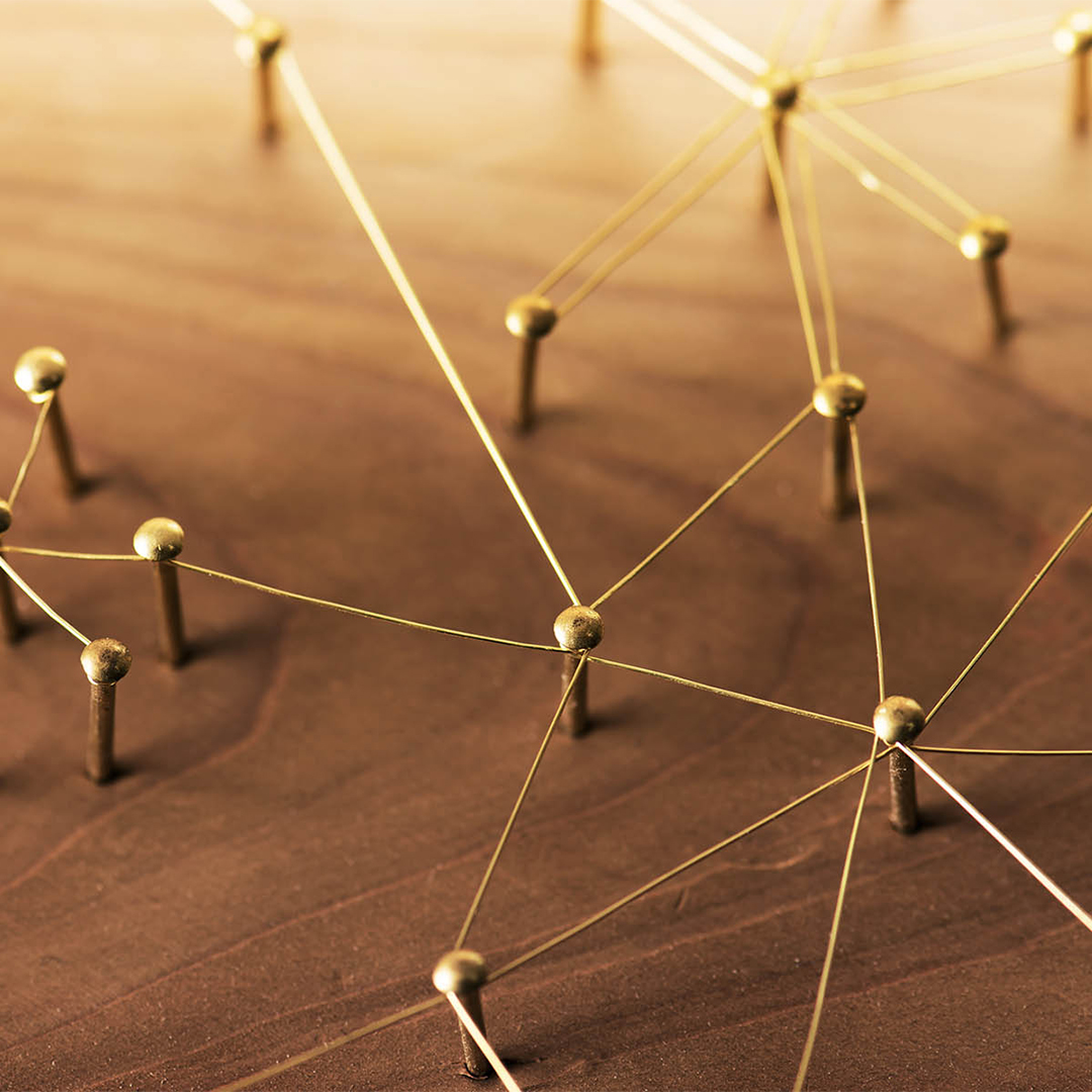 Gold nails in a wooden board, joined by interconnecting wire - Odgers Executive Search Board Headhunters