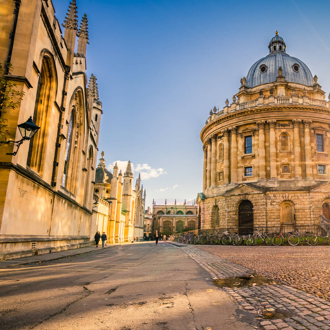 Old university buildings - cobbled street between two sandstone buildings with dome on top - Odgers Executive Search Board Headhunters